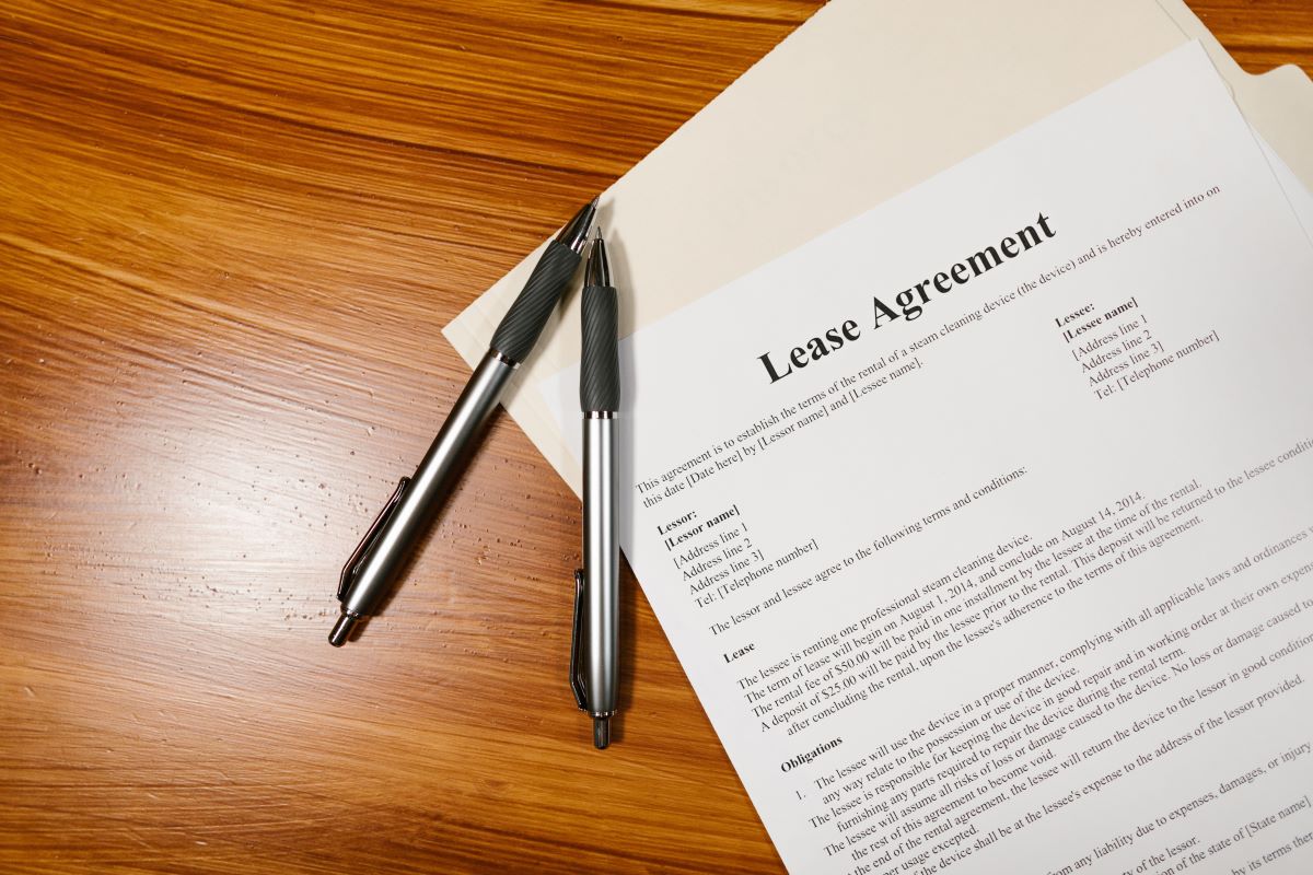 lease contract and two pens on a wooden table